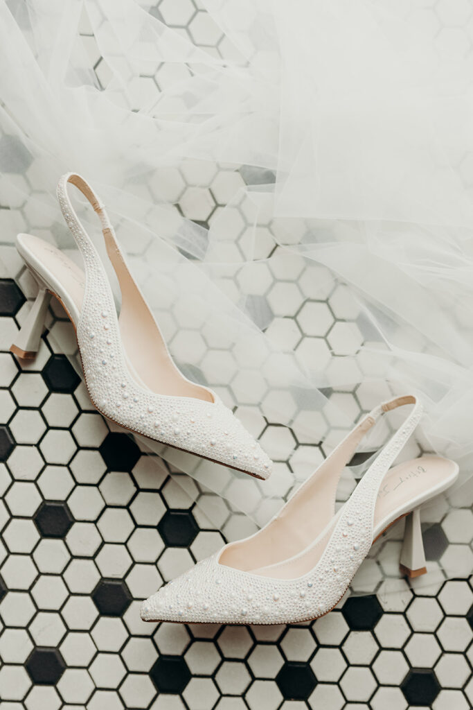 brides shoes on black and white tiles