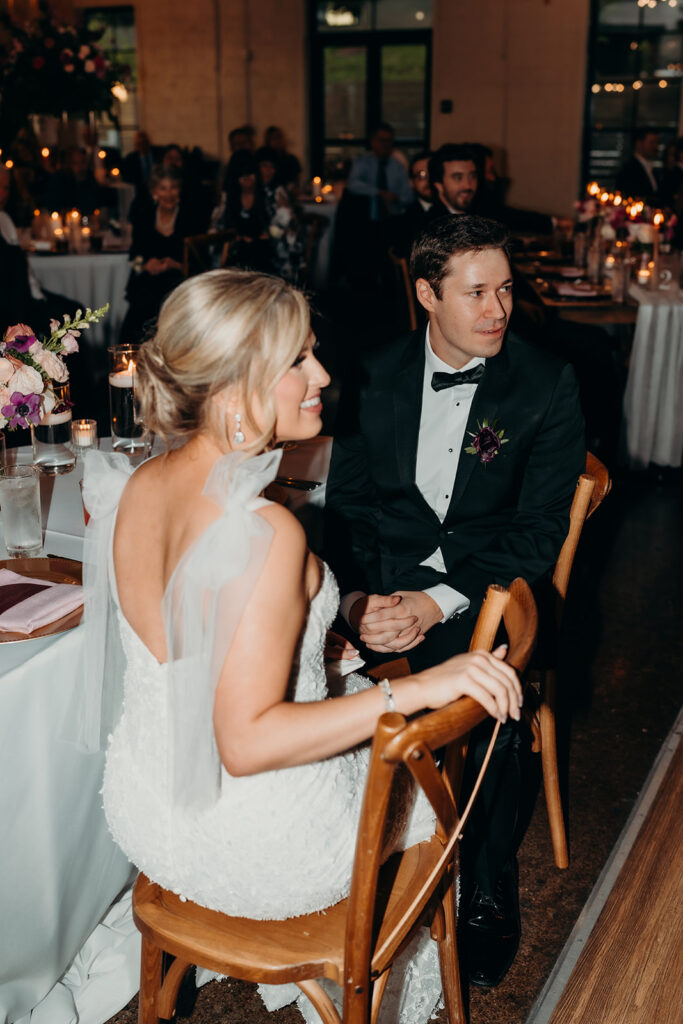 Bride and groom sitting at table for toasts