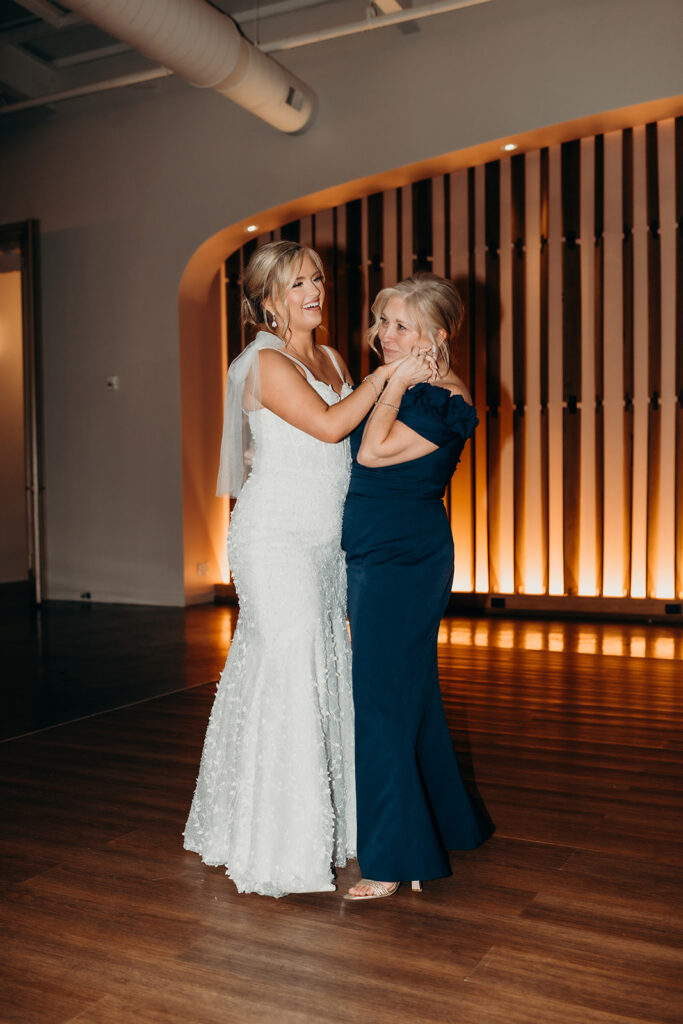 bride and mom dancing at wedding