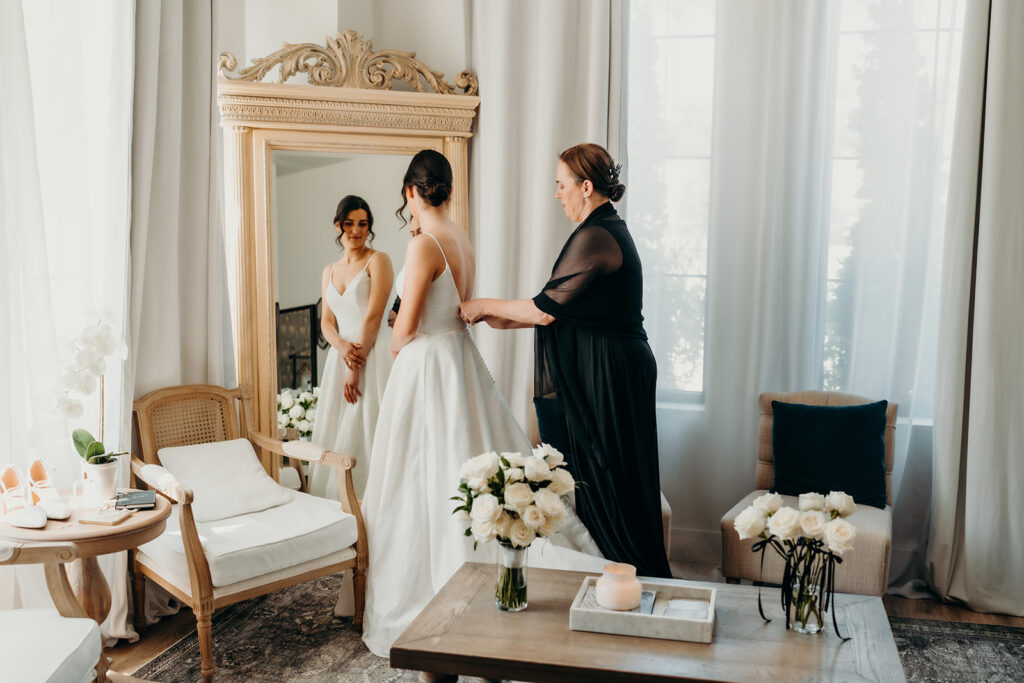 bride and mom getting ready in bridal suite