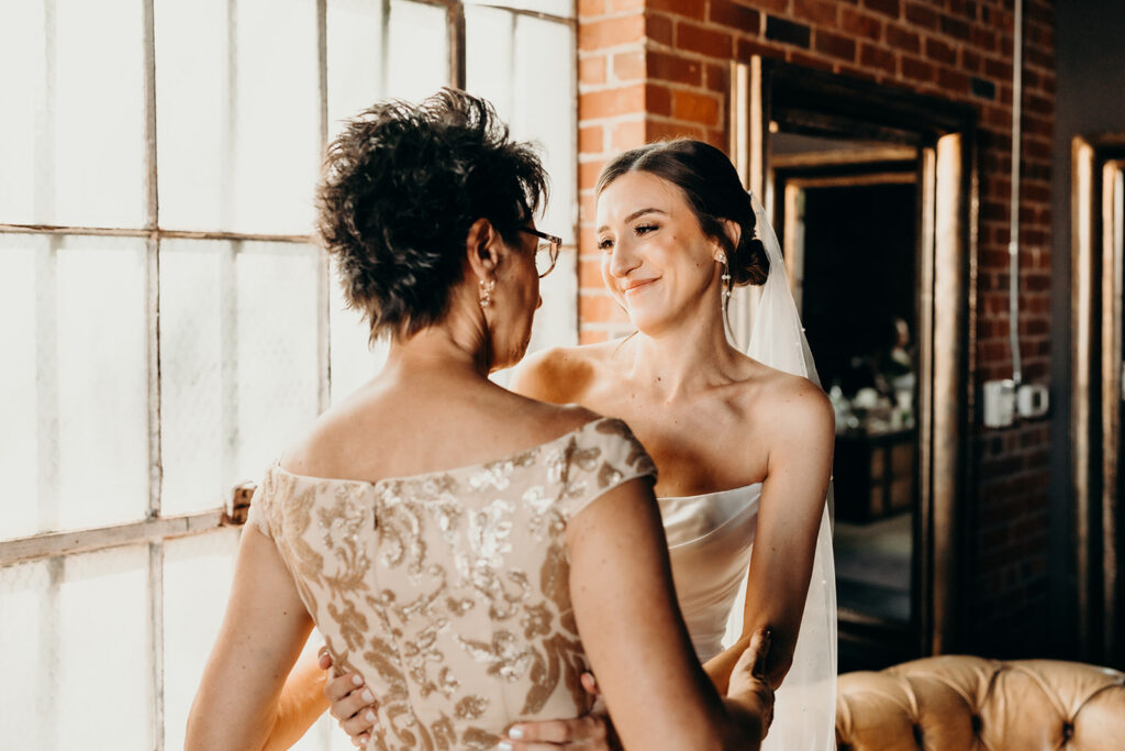 bride and mom sharing a sweet moment in the bridal suite