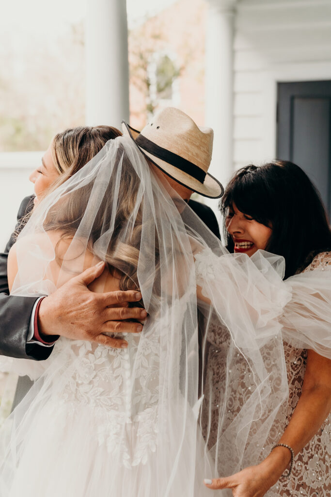 bride hugging her parents