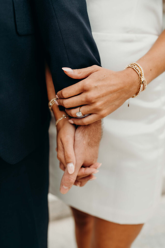 couple in white dress and navy blue suit and tie at classic courthouse building in uptown charlotte