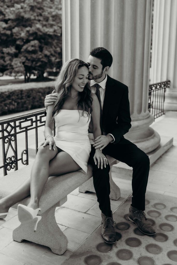 couple in white dress and navy blue suit and tie at classic courthouse building