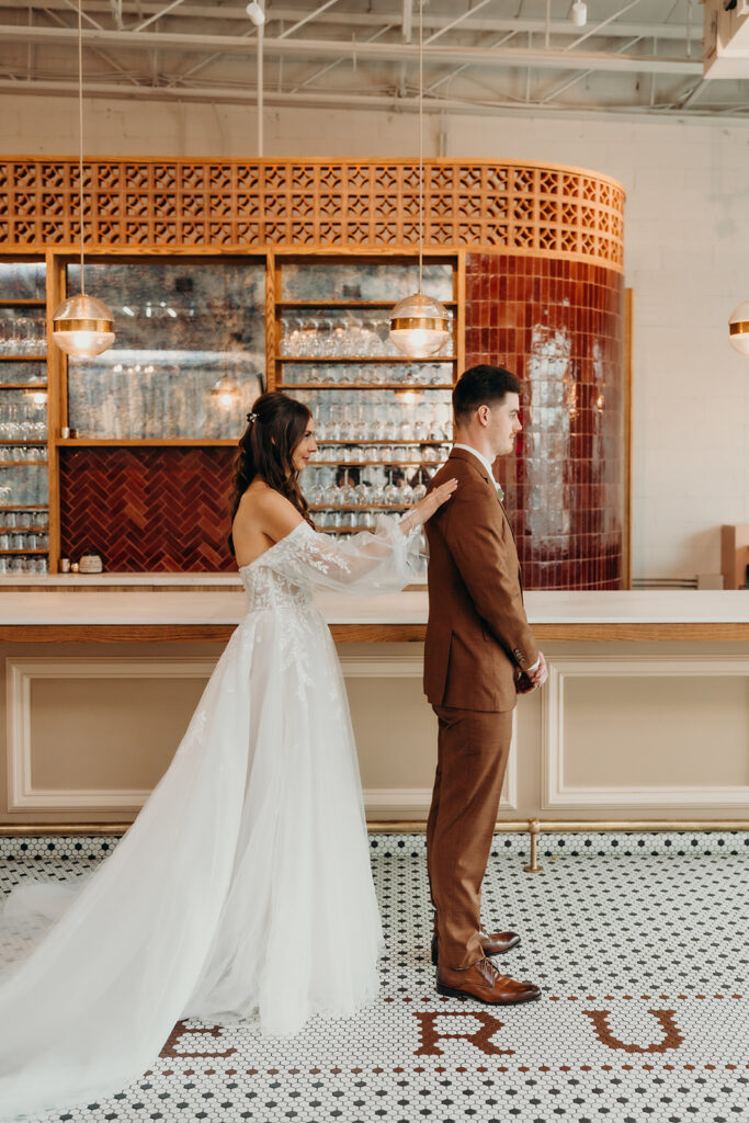 bride and groom first look at bar