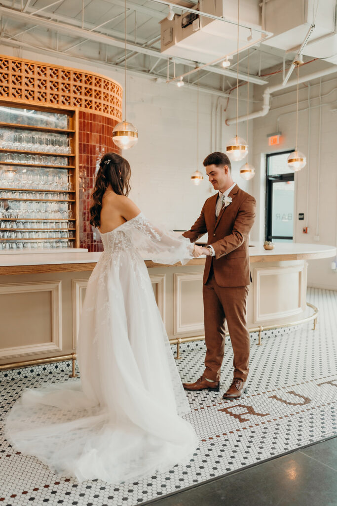 bride and groom first look at bar