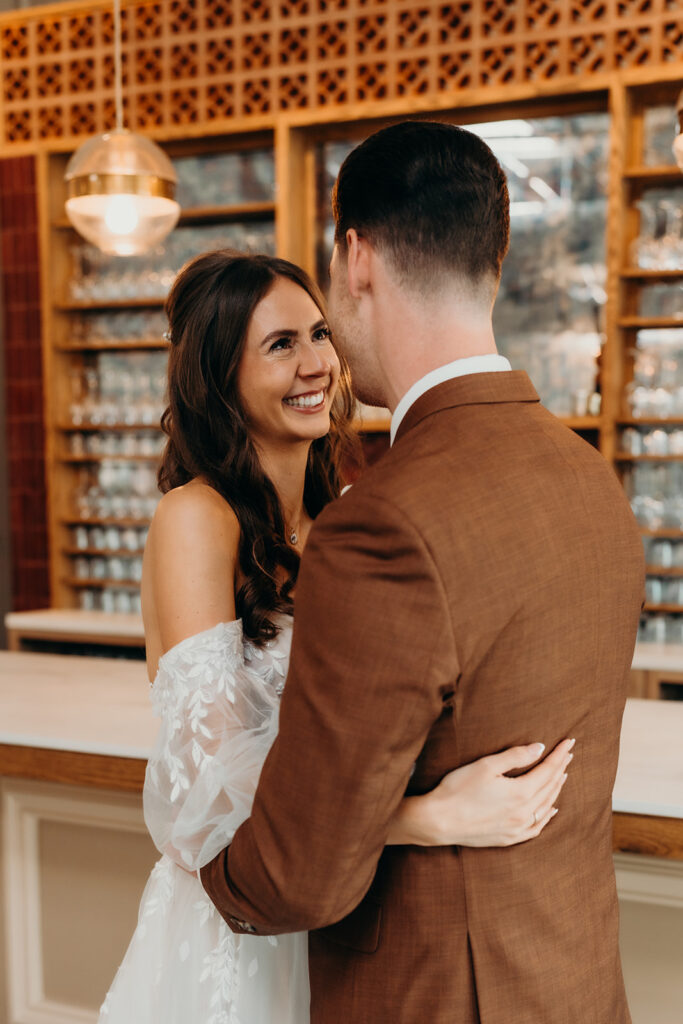 bride and groom first look at bar