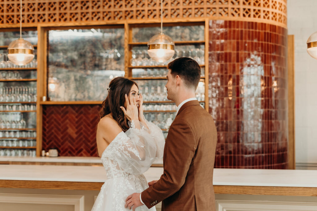 bride and groom first look at bar
