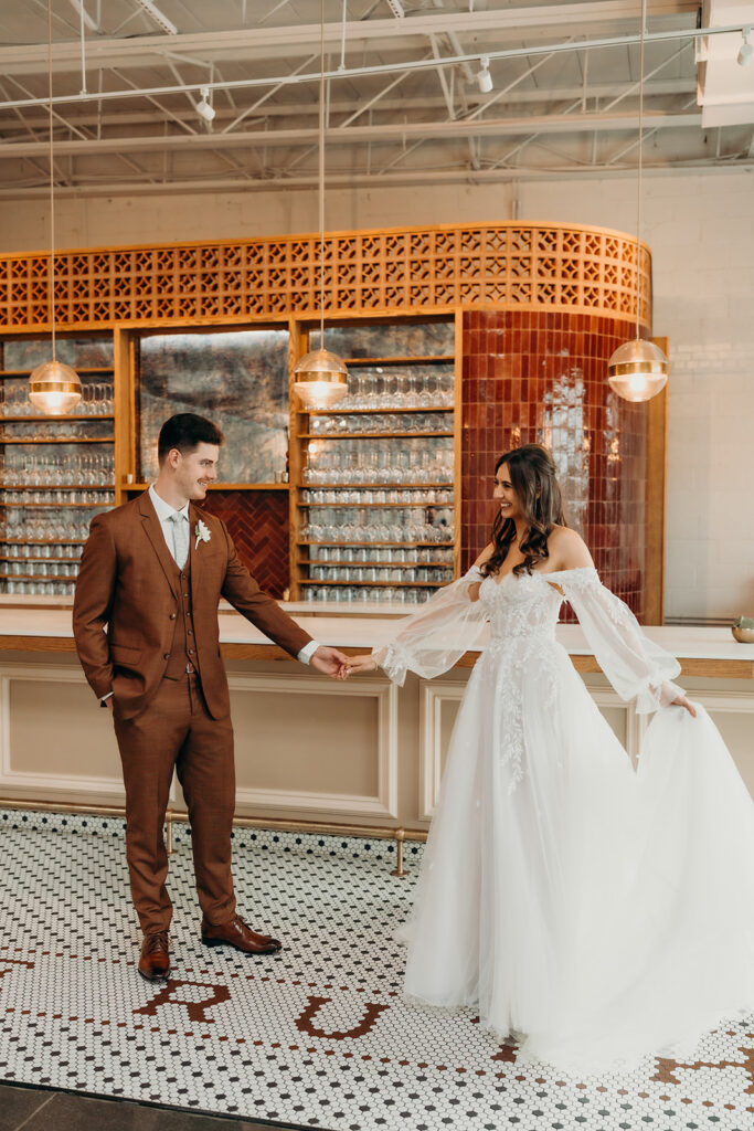 bride and groom first look at bar