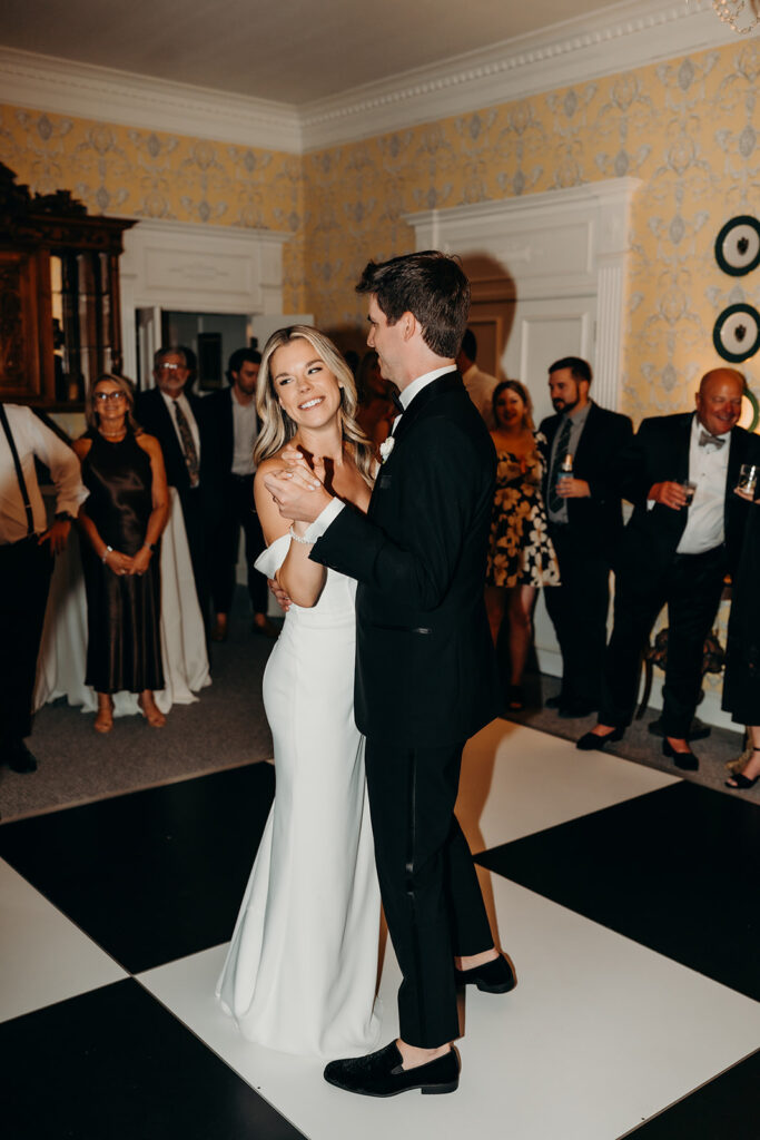 Summer wedding reception with checkered dance floor first dance