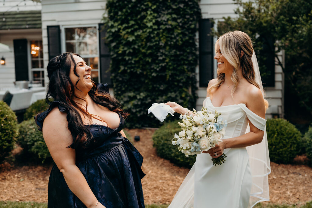 Bride and sister sharing a moment where sister gives her a gift