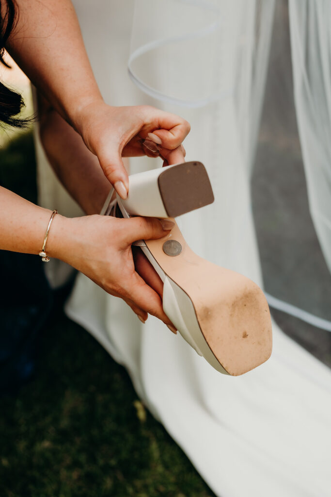 Bridesmaid fixing brides outfit