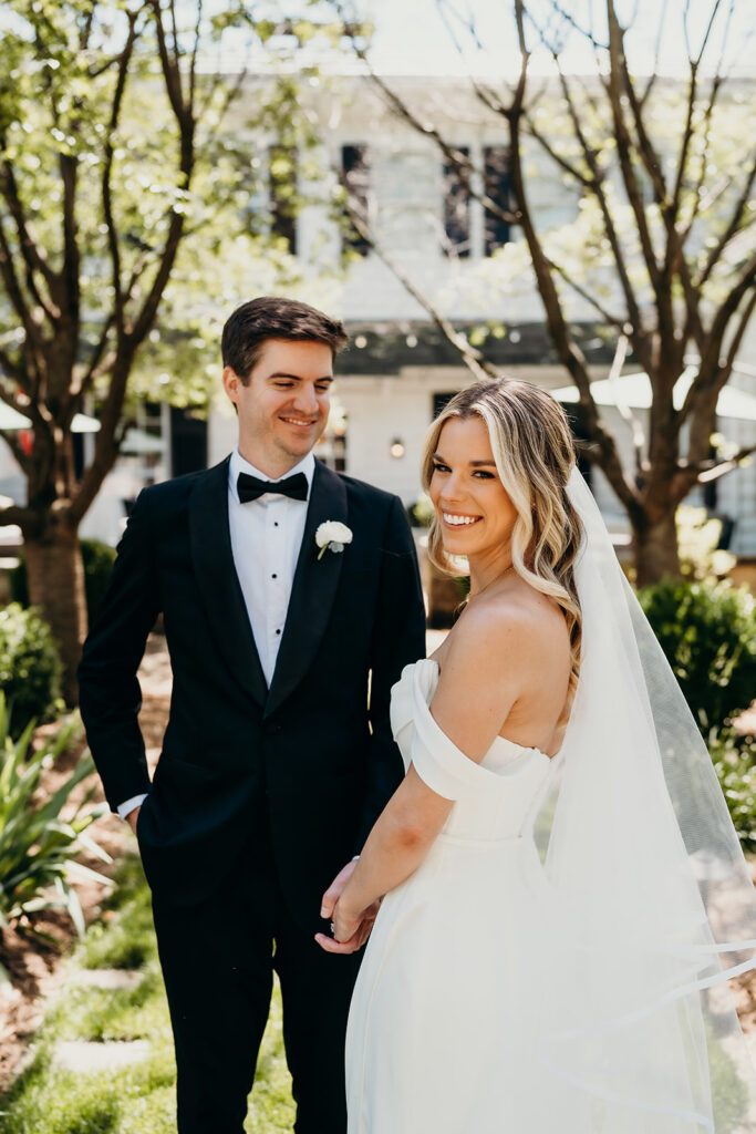 Candid first look portraits in courtyard 