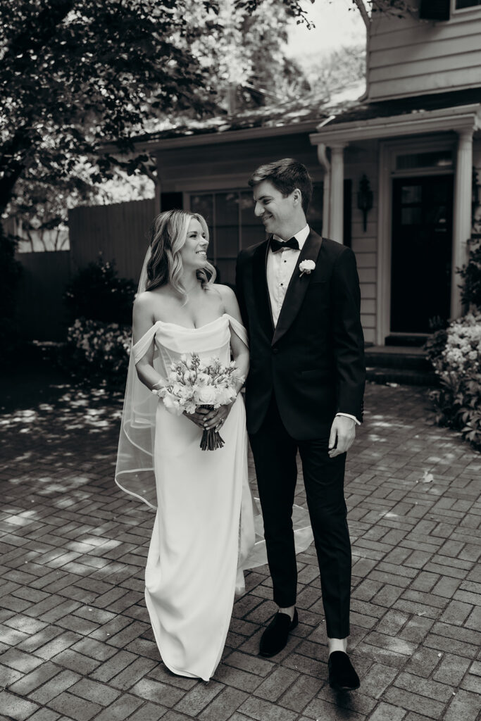 Candid first look portraits in courtyard