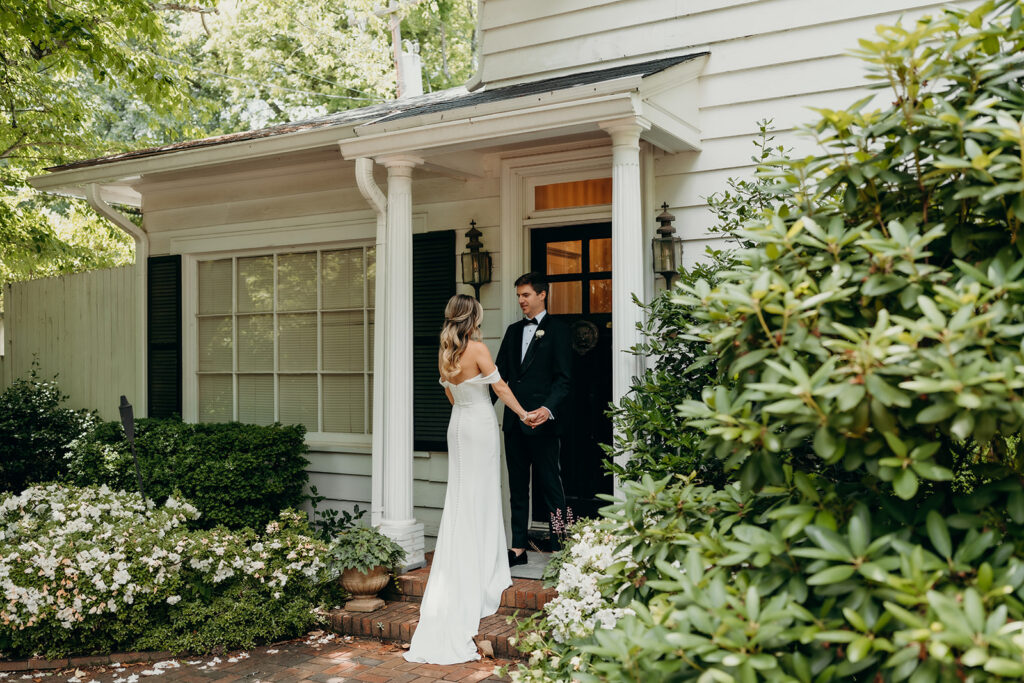 Candid first look portraits in courtyard