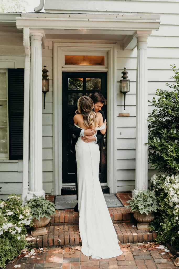 Candid first look portraits in courtyard