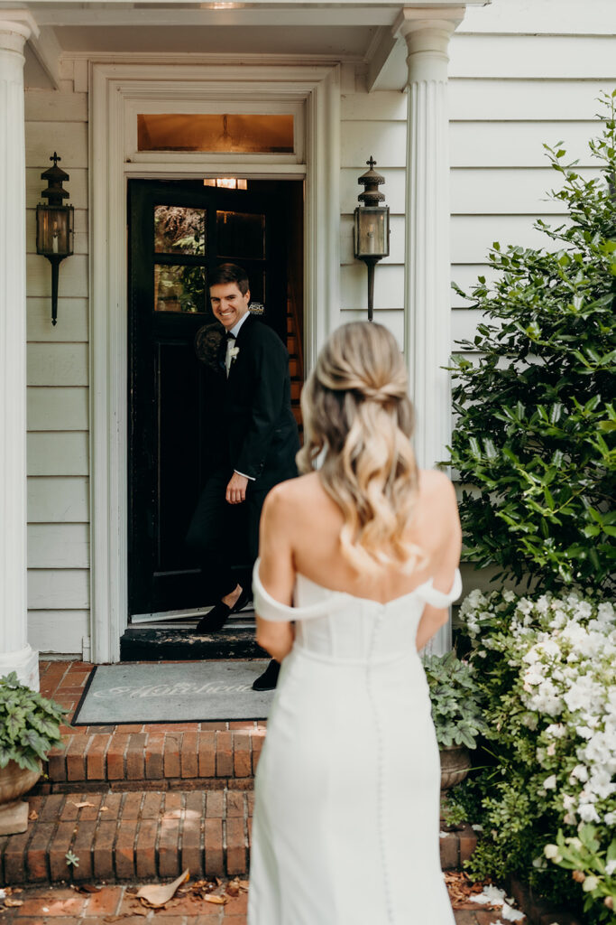 Candid first look portraits in courtyard