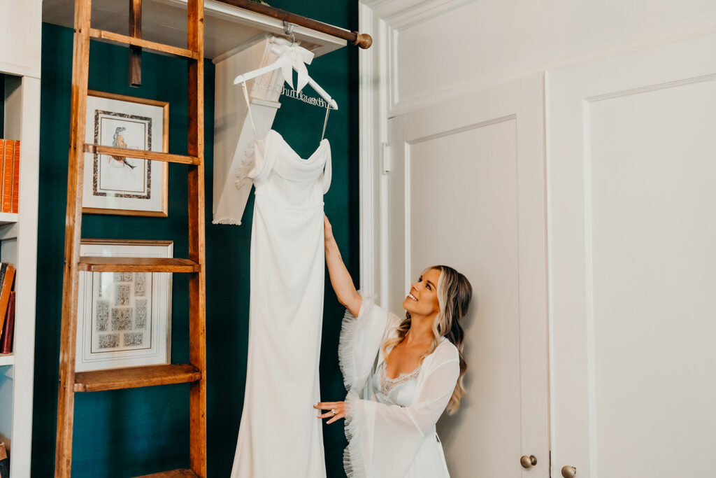 getting ready photos with bride grabbing dress and holding it
