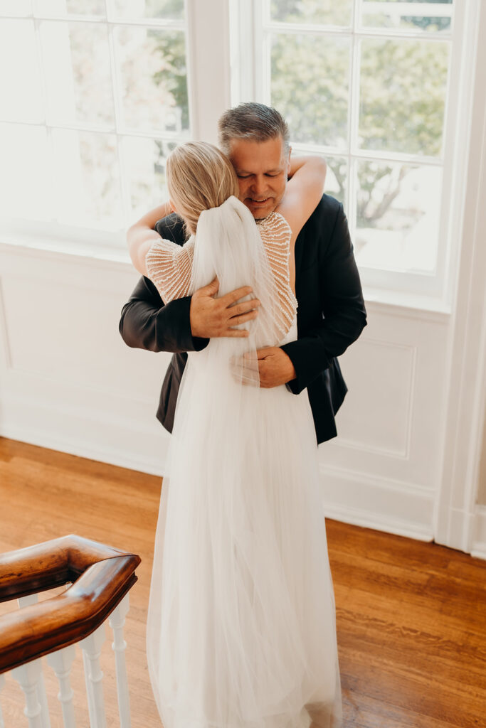 bride and dad first look on steps