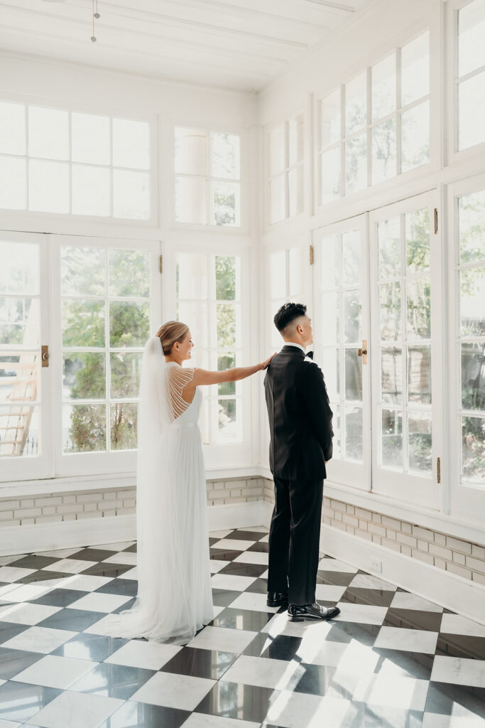 bride and groom first look on checkered floors at separk mansion