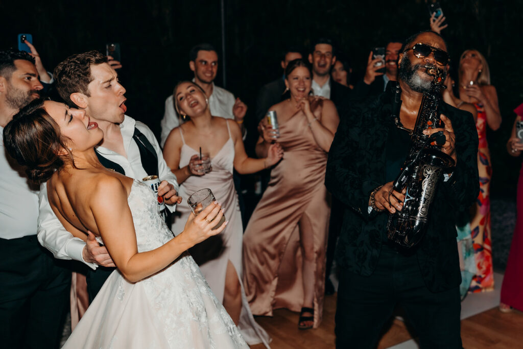 lively energetic dance floor outdoors with market lights and live sax