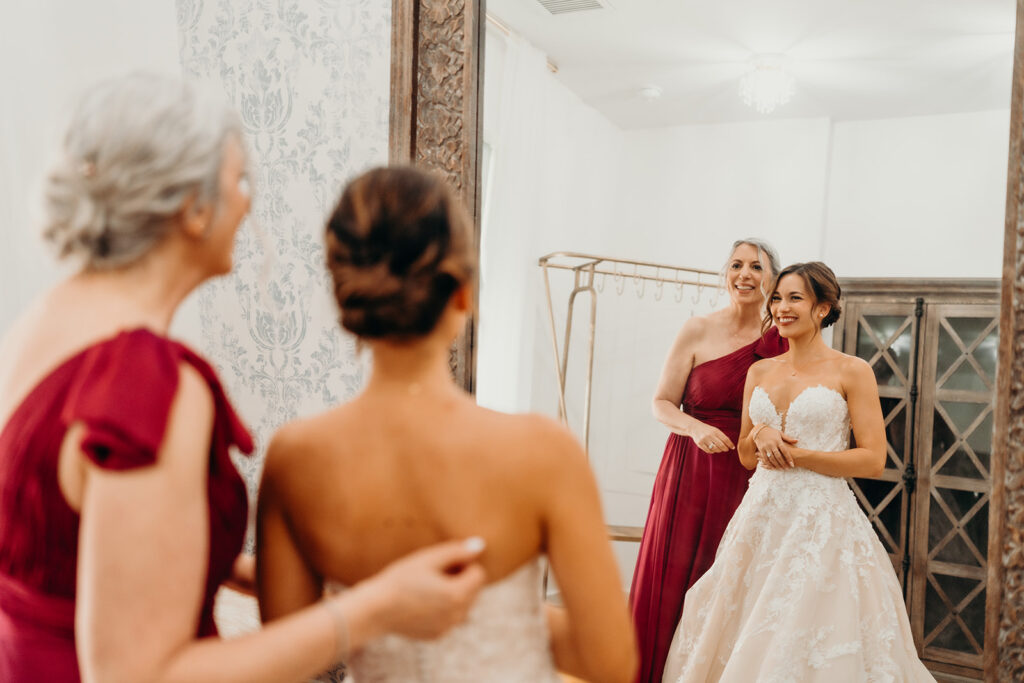 Bride getting ready photos getting into dress and putting on jewelry