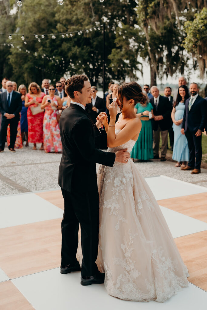 reception outdoors with checkered floor dance floor, happy tears, first dances, and toasts