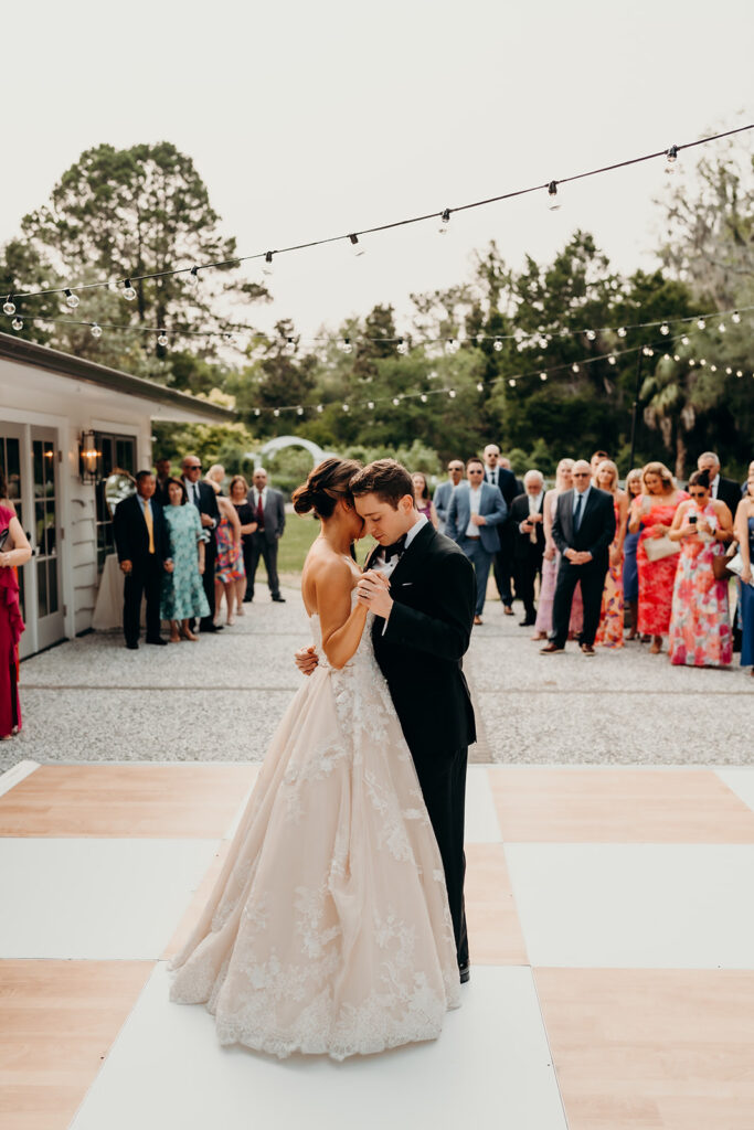 reception outdoors with checkered floor dance floor, happy tears, first dances, and toasts