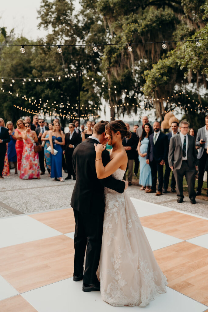 reception outdoors with checkered floor dance floor, happy tears, first dances, and toasts