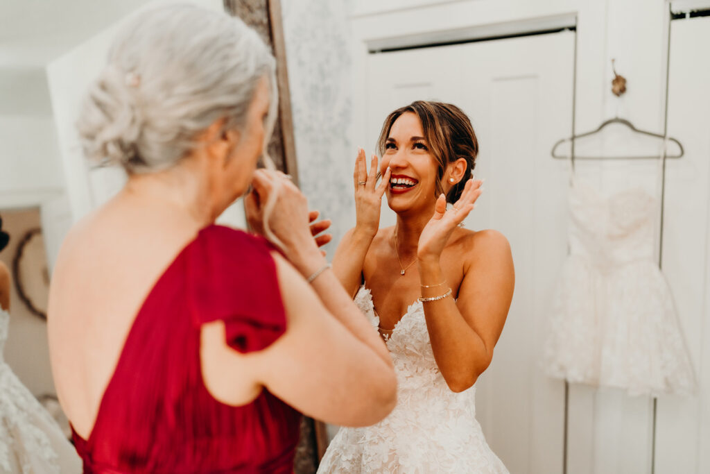 Bride getting ready photos getting into dress and putting on jewelry