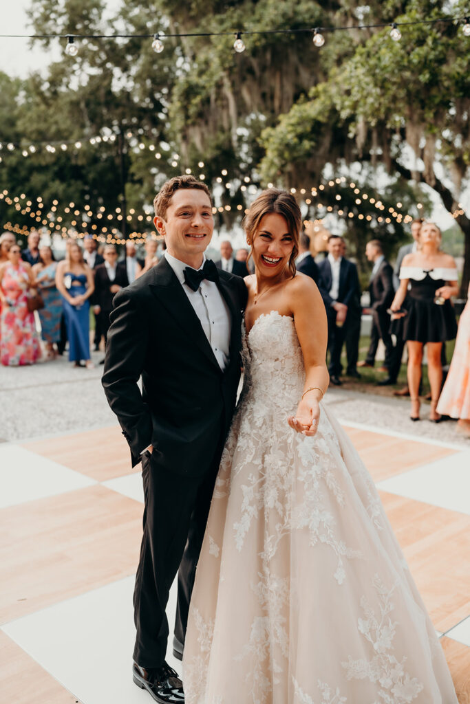 reception outdoors with checkered floor dance floor, happy tears, first dances, and toasts