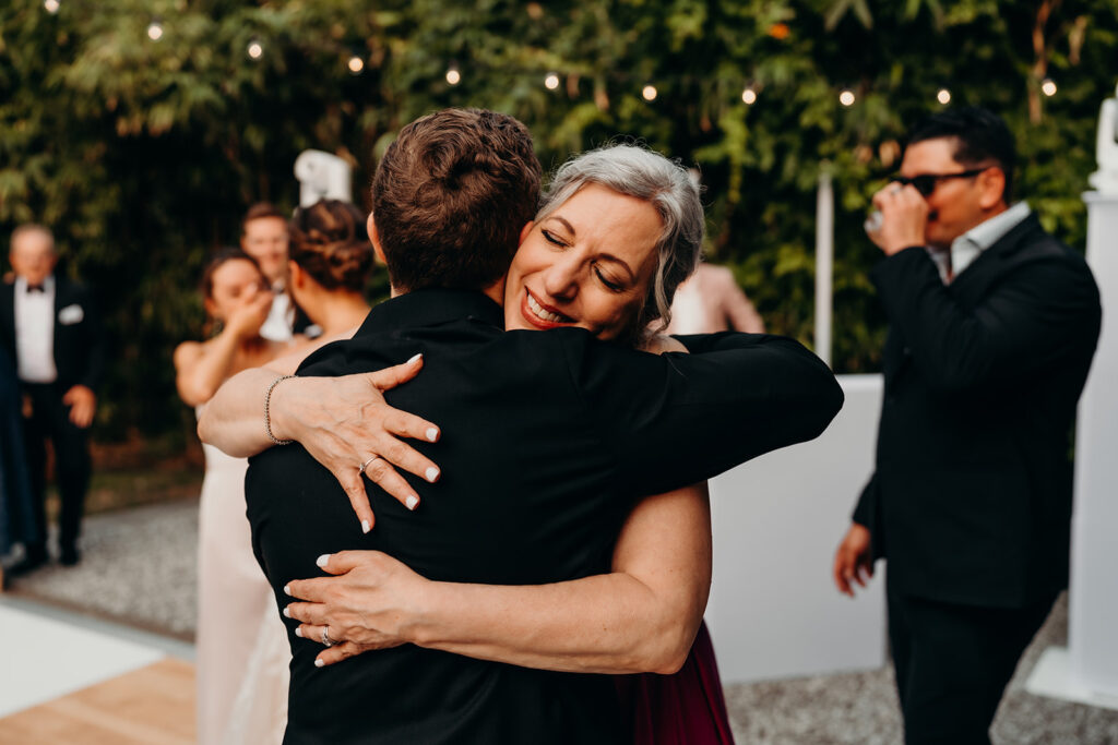 reception outdoors with checkered floor dance floor, happy tears, first dances, and toasts