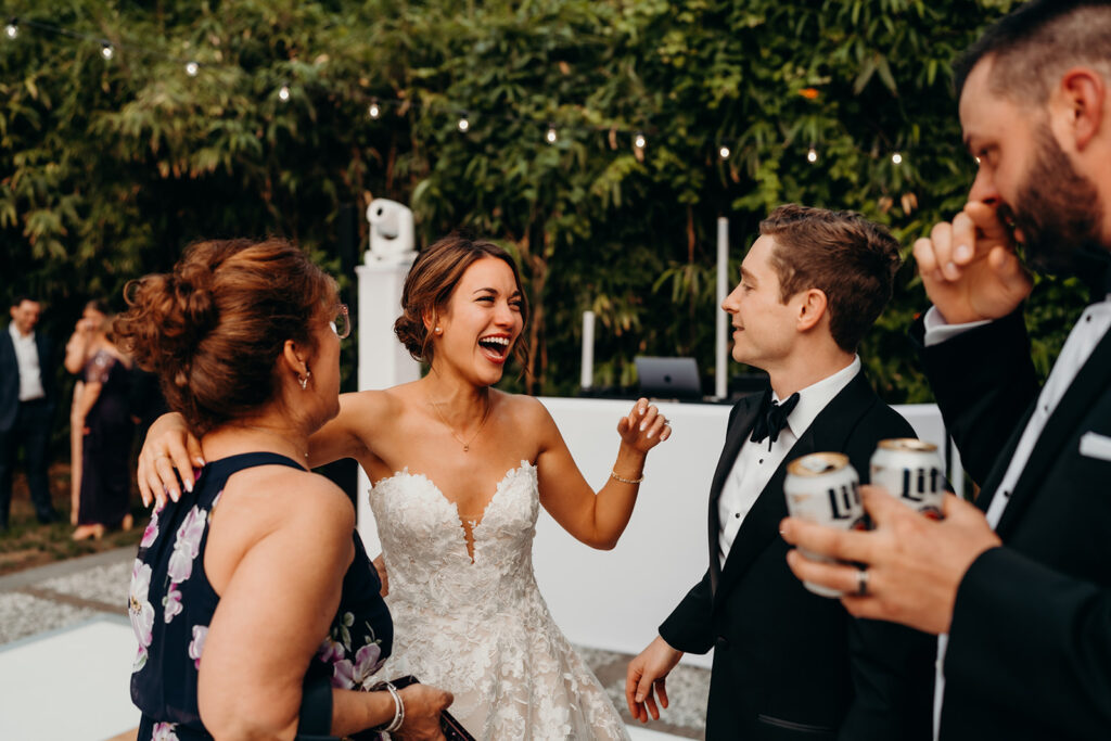 reception outdoors with checkered floor dance floor, happy tears, first dances, and toasts