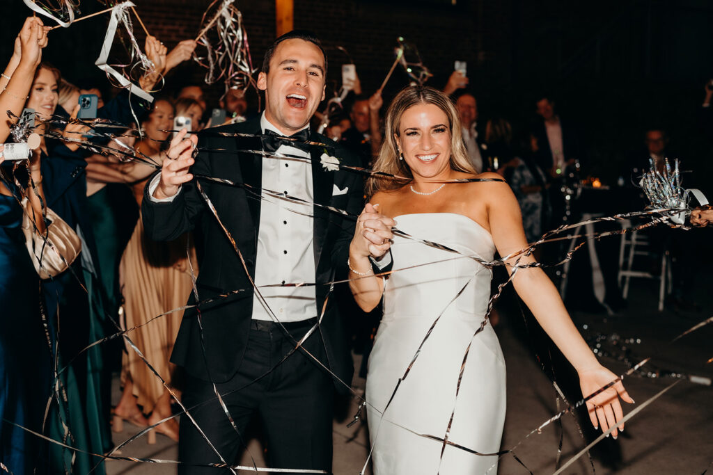 wedding reception at the cedar room couple exit with streamers