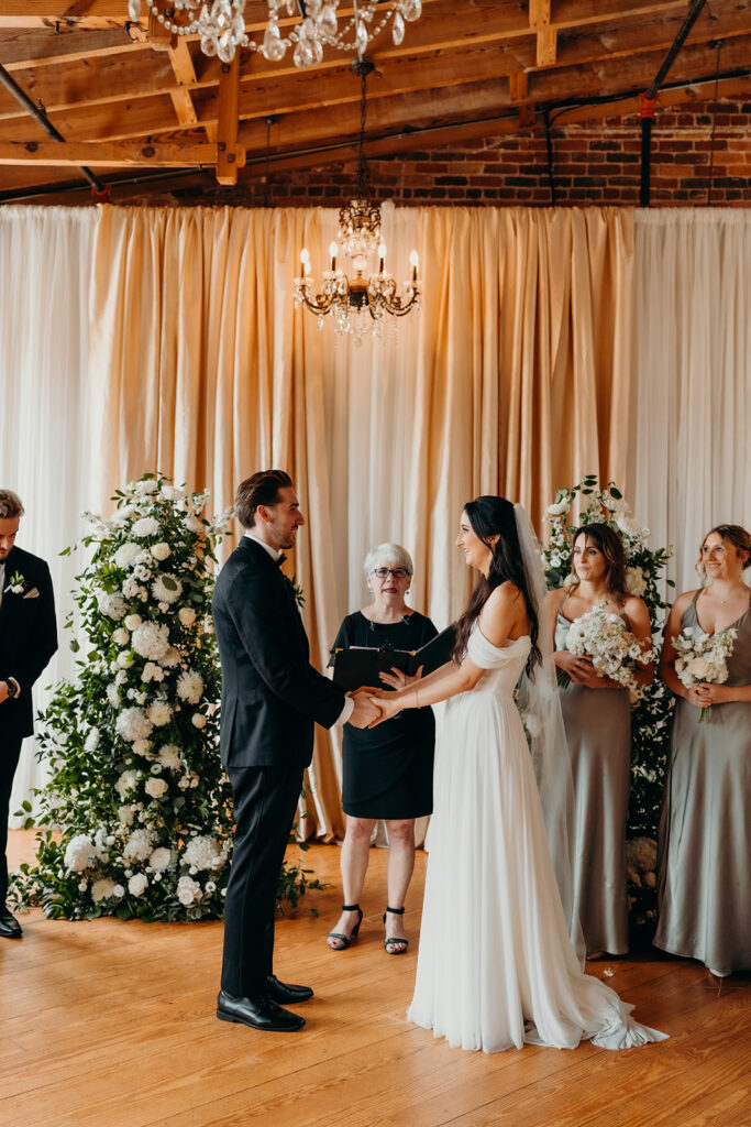 couple during ceremony at melrose knitting mill