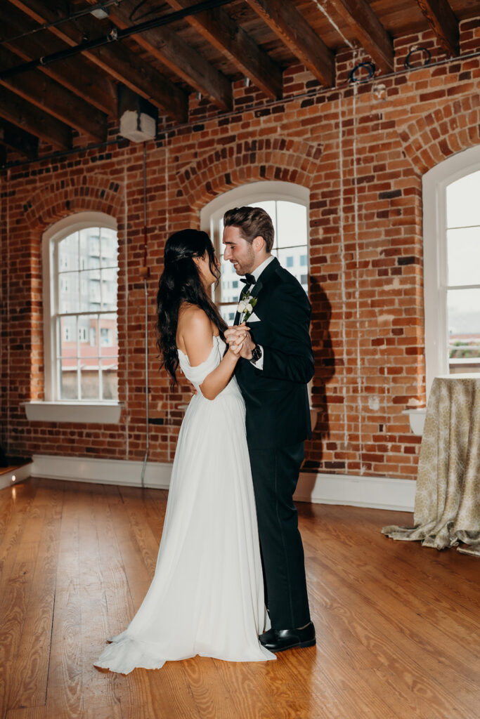 couple doing their first dance at Melrose Knitting Mill