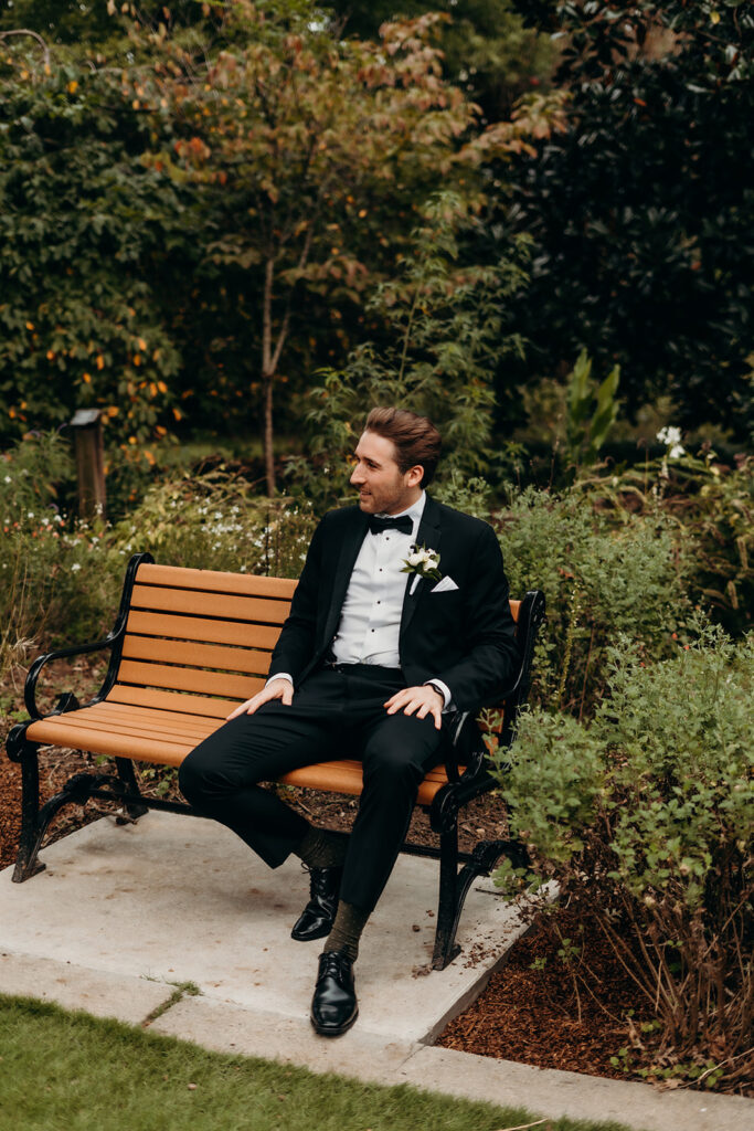groom waiting for bride on bench