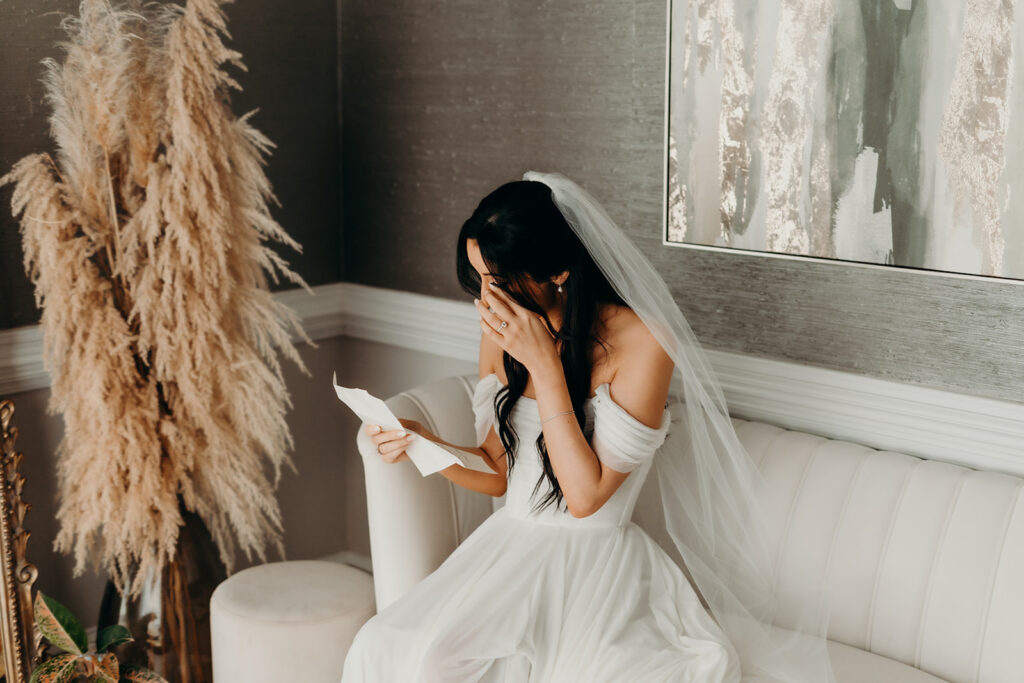 bride crying while reading letter from the groom