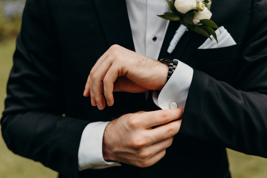 grooms portraits adjusting cufflinks