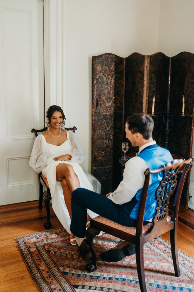 bride and groom taking a break to breathe and rest in the side room at their rose hill estate wedding