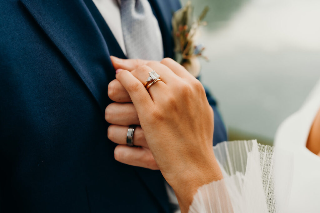 bride and groom detail shots of their new wedding bands on their hands