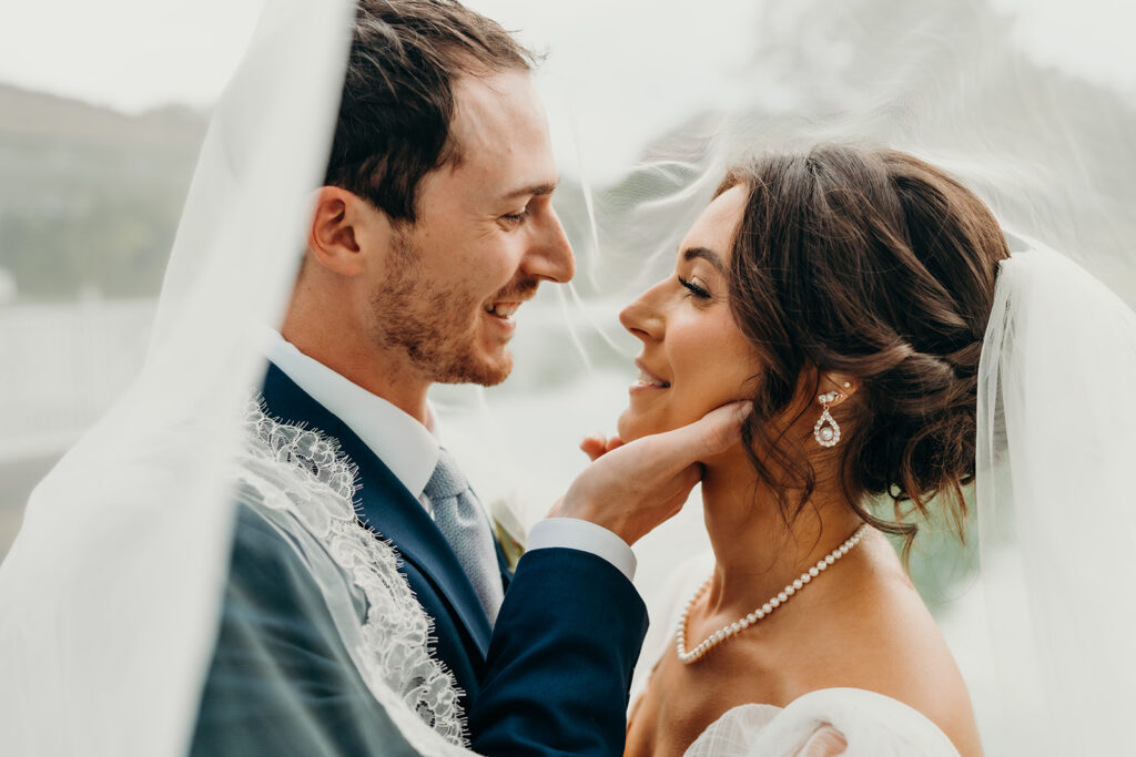 groom hold brides face as he pulls her in for a kiss at their rose hill estate wedding