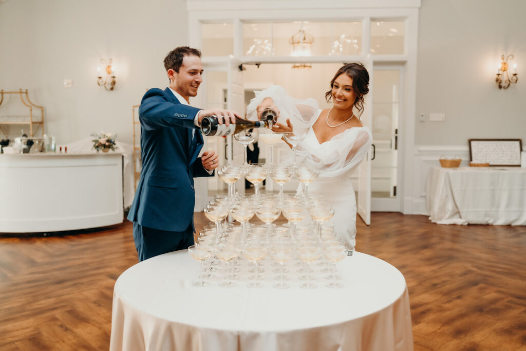 bride and groom pouring their champagne tower at their rose hill estate wedding