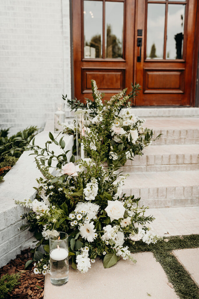 white florals outside the bradford wedding venue on the steps