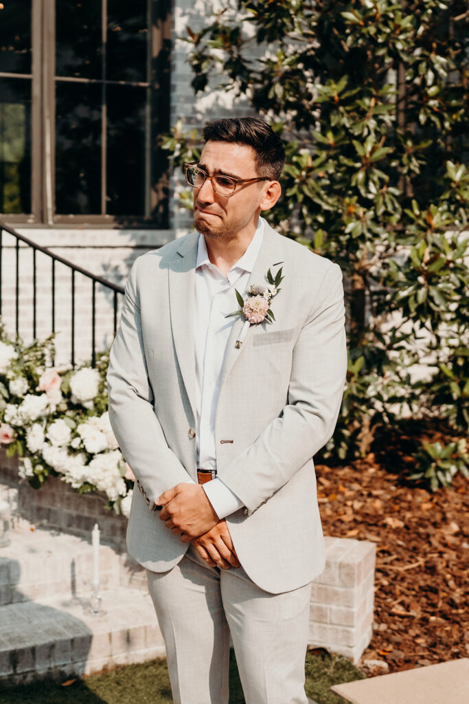 groom crying as bride walks down the aisle