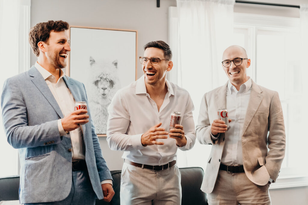 groom and friends getting ready and laughing 