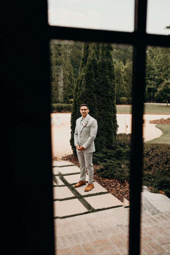 groom waiting for bride at first look