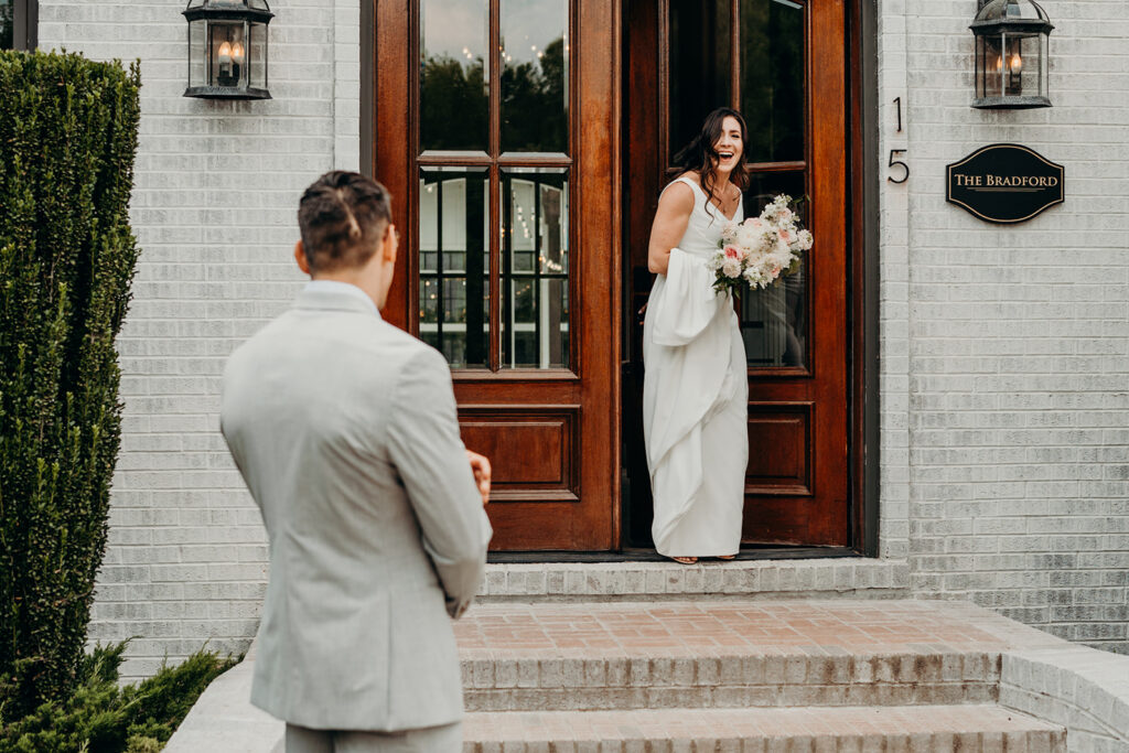 bride coming out the wooden door at the bradford wedding venue during first look