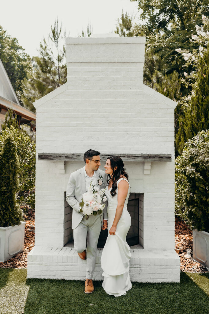 bride and groom portraits in front of fireplace