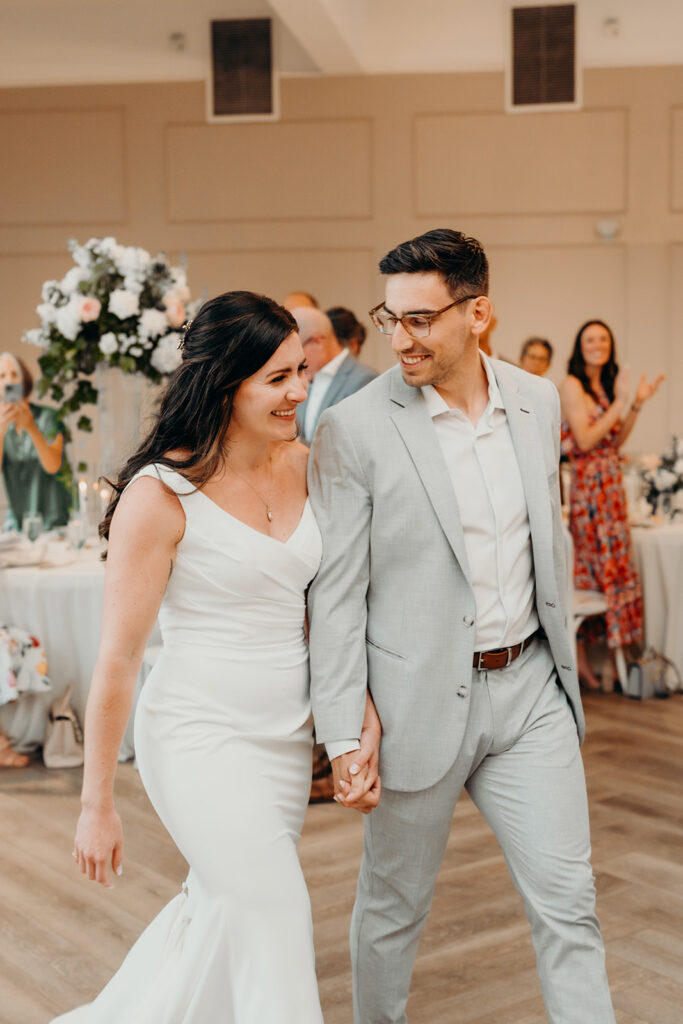 bride and groom entering reception